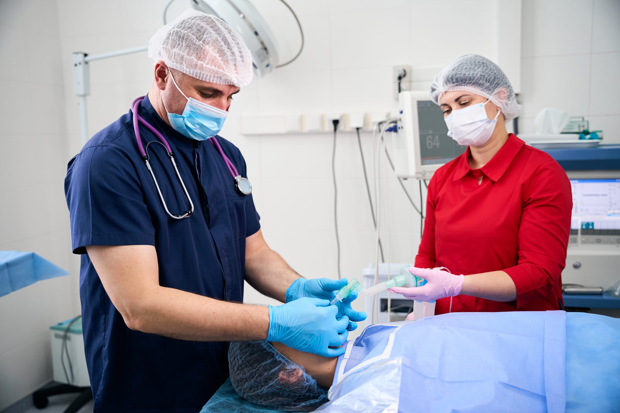 An anesthesia care team at work in an operating room